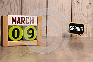 9 Marz on wooden grey cubes. Calendar cube date 09 March. Concept of date. Copy space for text or event. Educational