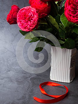 9 May background - red roses and red ribbon on the concrete background, free space for text