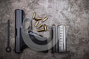 9 mm. Semi automatic pistol handgun and ammunition magazine on old cement texture background , Germany gun