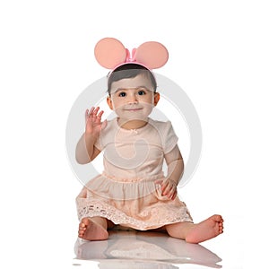 9 month infant child baby girl toddler sitting in white shirt isolated
