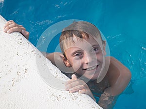 9 year old boy having fun in swimming pool