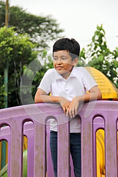 9-year-old dark-skinned Latino boy plays in a playground as a physical activity living in poverty as therapy for ADHD