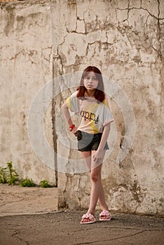 9 years old girl on summer. Teenager in a light T-shirt with a serious expression on her face. An emotion of seriousness