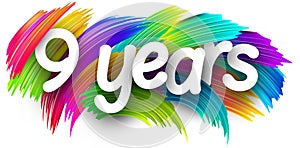 9 years paper word sign with colorful spectrum paint brush strokes over white