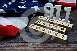 911 We will Never Forget alphabet letters with USA Flag on wooden background
