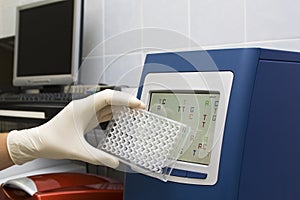 96 well plate in scientist's hand