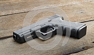 9mm pistol on wooden background with Copy Space