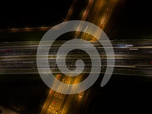 A10 Highway traffic at night. Motorway infrastructure in darkness light of dynamic moving traffic on the road at