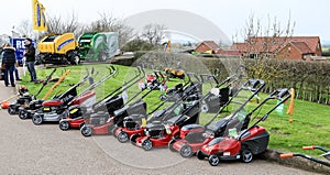 A row of red lawn mowers