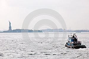 AA tugboat heads towards Liberty Island photo
