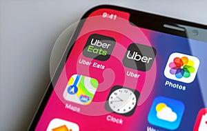 Apple iphone with Uber and Uber Eats App on screen. Uber is an American company offering different transportation services online