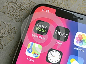 Apple iphone with Uber and Uber Eats App on screen. Uber is an American company offering different transportation services online