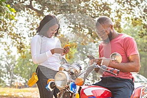 aafrican man and woman sharing content from their phones