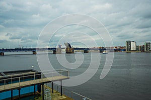 Aalborg, Denmark: Bascule bridge across the Langerak strait just opening for vessels, yacht board view
