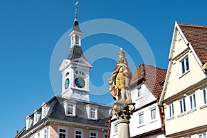 Aalen, Baden-Wuerttemberg, Germany. Old Town Hall with tower and statue of emperor Joseph I. on top of marketplace fountain