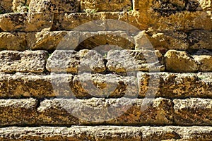 AAncient Greek stone wall closeup texture or background.