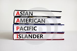 AAPI symbol. Abbreviation AAPI asian american pacific islander on books. Beautiful white background. Copy space. Business and AAPI