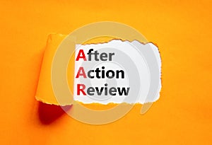 AAR After action review symbol. Concept words AAR After action review on beautiful white paper. Beautiful orange paper background