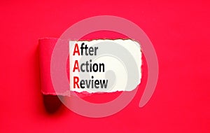 AAR After action review symbol. Concept words AAR After action review on beautiful white paper. Beautiful red paper background.