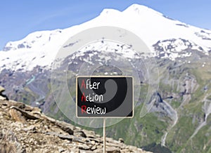 AAR After action review symbol. Concept words AAR After action review on beautiful yellow blackboard. Beautiful mountain Elbrus