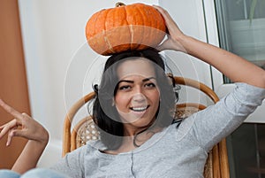 AAttractive girl with holding pumpkins in here ha