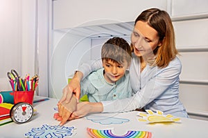 ABA therapy class woman teach autistic boy weather