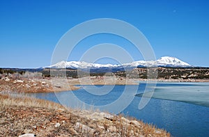 Abajo Mountains and winter lake in Utah