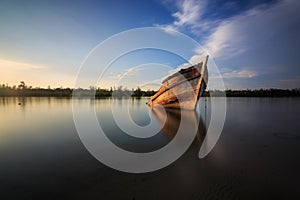 Abandon Old wreck on the shore , Borneo , Old fishing boat photo