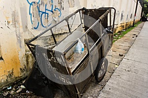 An abandon unmaintained cart for carrying garbage park on side the street photo taken in Jakarta Indonesia