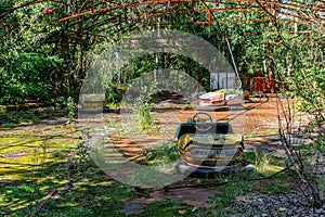 Abandoned Amusement Car Ride in park of attractions in Ghost City of Pripyat in Chernobyl Exclusion Zone