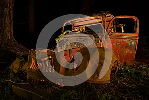 Abandoned Antique Rusting in the Forest at Night