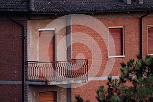 abandoned apartment with brick facades and closed windows, Italy photo