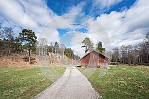 Abandoned barn beside a gravel road