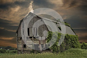 Abandoned barn with sunset sky