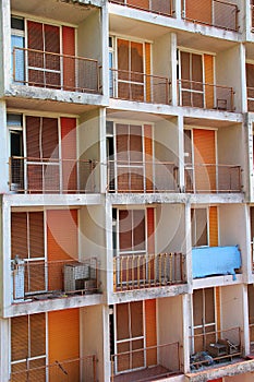 Abandoned block from communist times, orange balconies, orange window blinds, closed window blinds, many balconies, Rijeka,