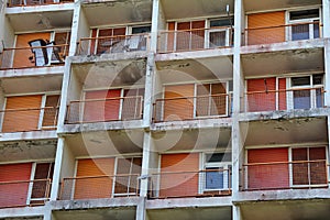 Abandoned block from communist times, orange balconies, orange window blinds, closed window blinds, many balconies, Rijeka,