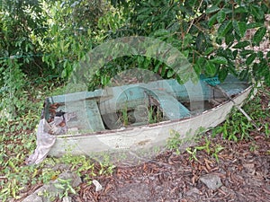 Abandoned blue boat in a village close-up