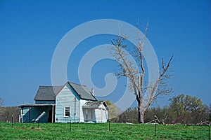 Abandoned blue farm house