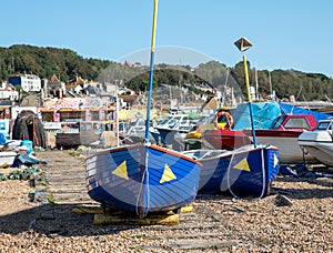 Abandoned blue fishing boats on the shore in Hastings UK