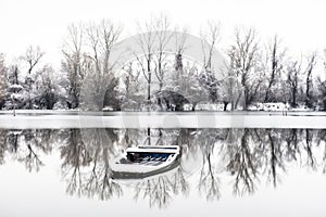 Abandoned boat in a frozen lake