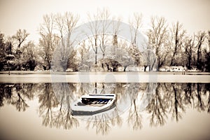 Abandoned boat in a frozen lake