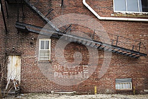 Abandoned brick building with metal staircase