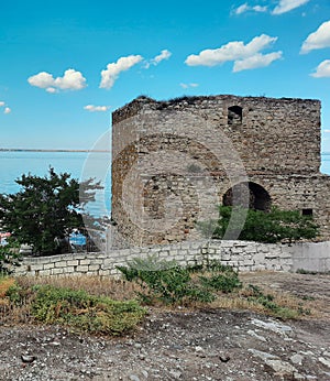 Abandoned brick docks overgrown with moss. An ancient ruined building on the pier.