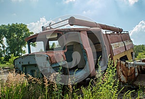 Abandoned broken old fire station truck during summer in the lost forgotten village