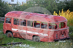 Abandoned broken red bus at Chersky town
