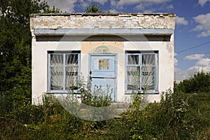 Abandoned building of a closed grocery store with grassed stairs in Topilly railway station of Ryazan region, Russia.