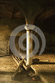 Abandoned building with column and arch.