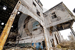 Abandoned building with debris in the city after the war. Broken house on ruin demolishing site after destruction