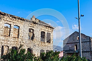 Abandoned building, detroyed during Bosnian War at Bulevar Street in Mostar city, Bosnia and Herzegovina photo