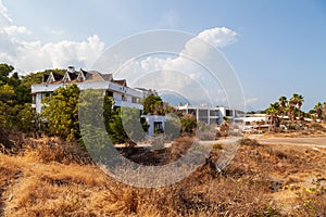 Abandoned building exterior view of Hotel in the Turkish village of kemer with broken windows and overgrown plants